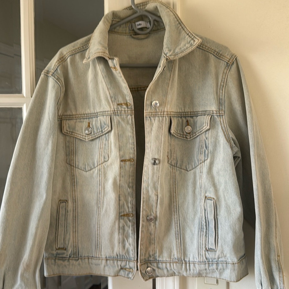 Adika, light blue denim jean jacket with lightning design on back good condition